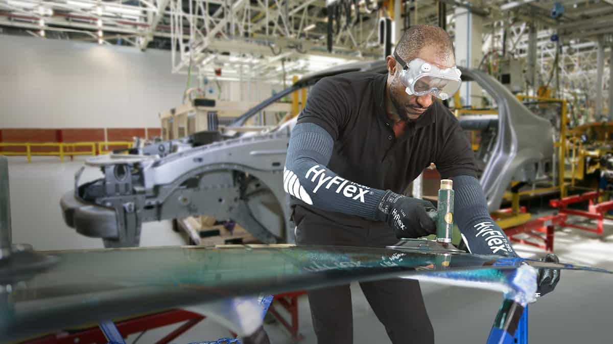 Worker wearing cut resistant gloves